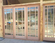 New construction site featuring exterior folding patio doors made from mahogany wood
