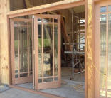 Folding patio doors stack to one side to open interior to exterior
