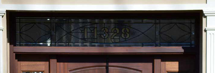 Door transom with house number in glass